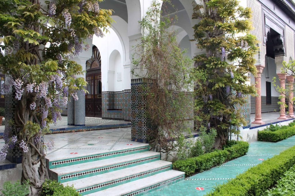 A photo of steps leading down to the main level of the gardens of the Grand Mosque of Paris.