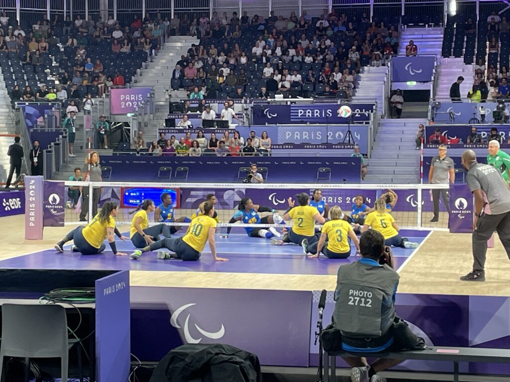 A photo of a sitting volleyball game between Rwanda and Brazil at the 2024 Paralympics.